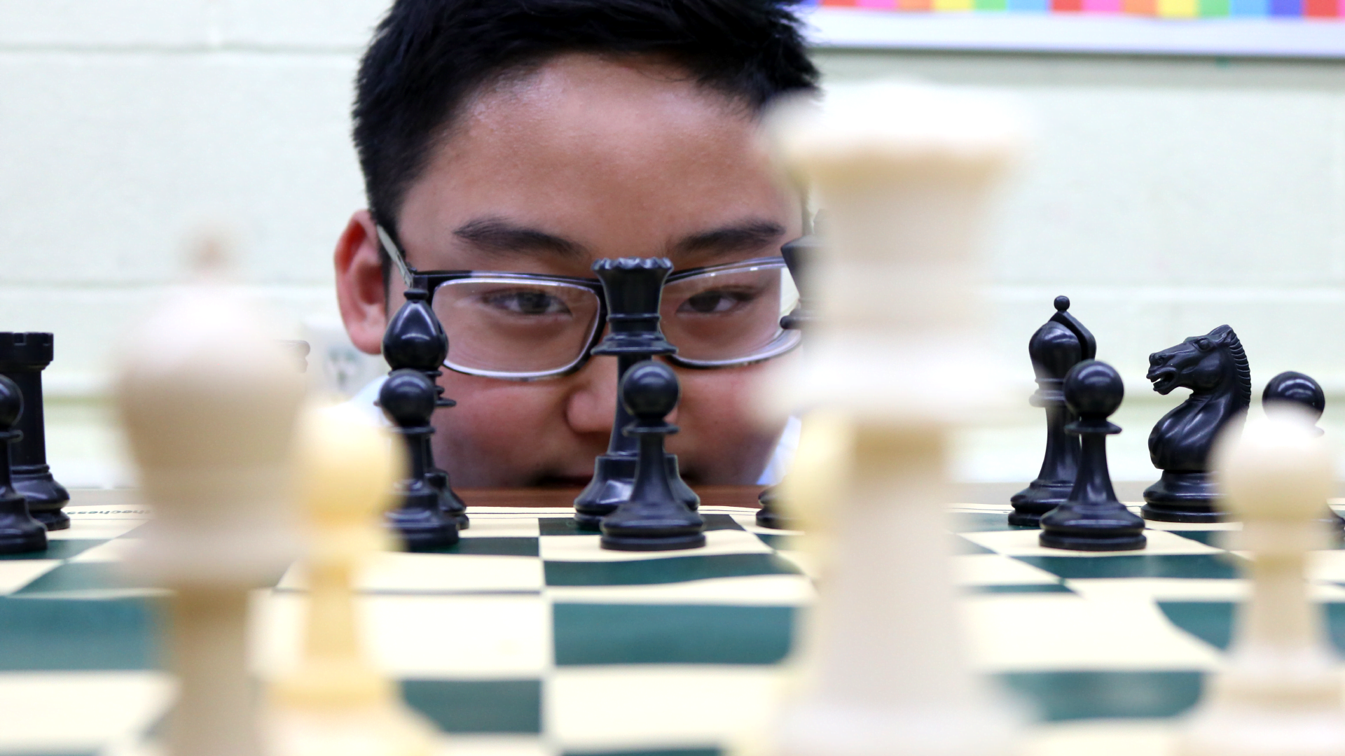 student staring at chess board
